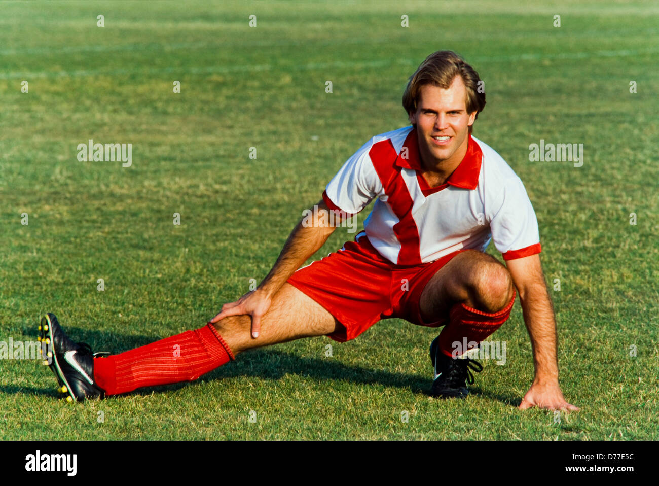 Man in soccer uniform stretching before game, Miami Stock Photo