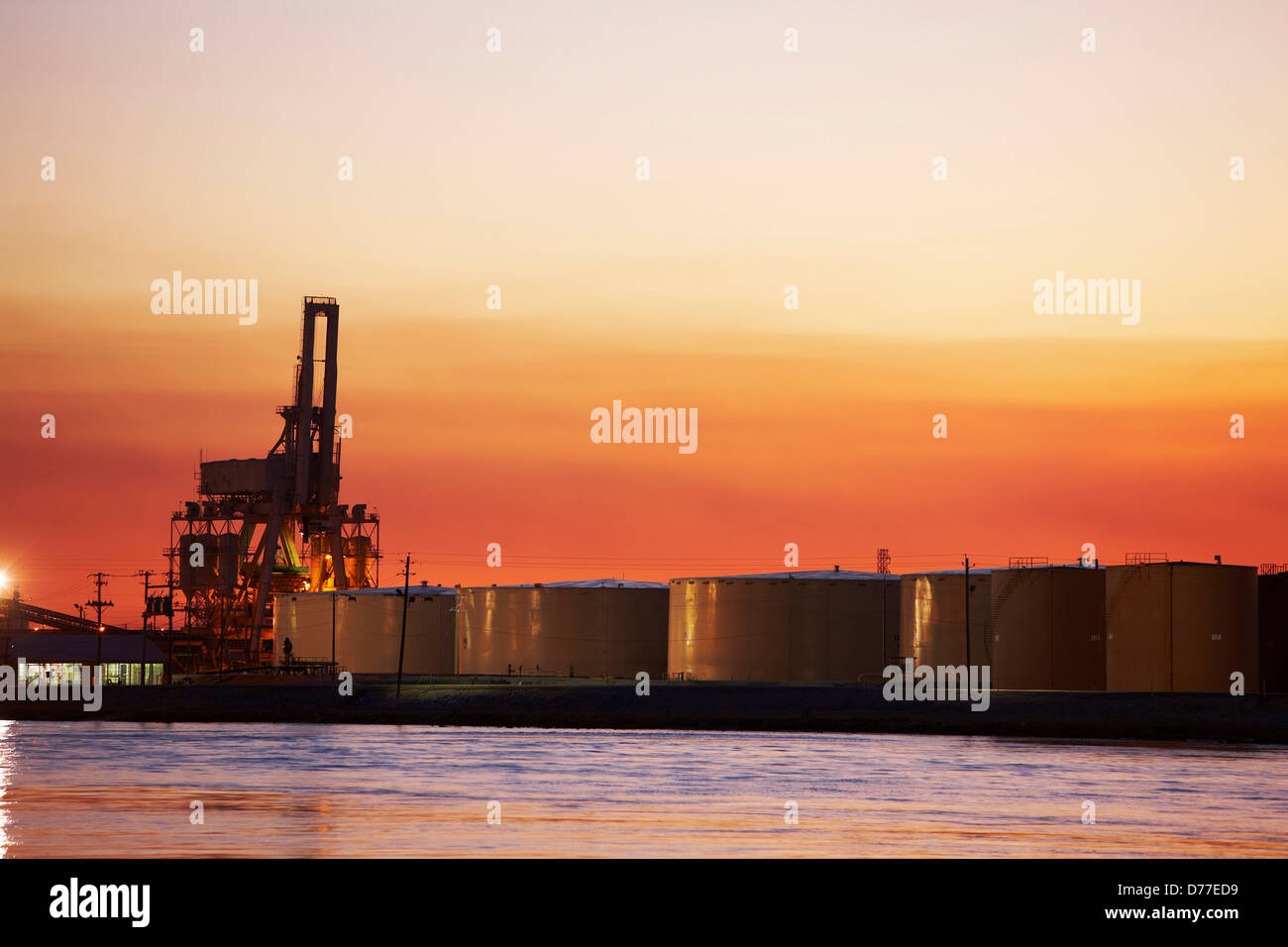 Large oil tanks container loader in distance Mobile River Mobile