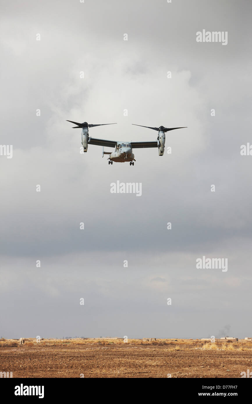 United States Marine Corps MV-22 Osprey approaches unimproved landing zone austere combat outpost in Helmand Province Stock Photo