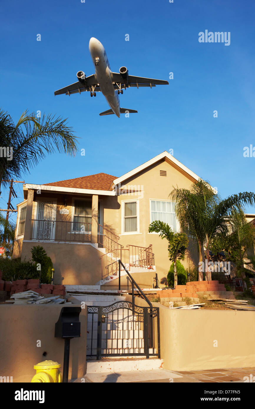 USA California San Diego Jet airliner flying low over house Stock Photo