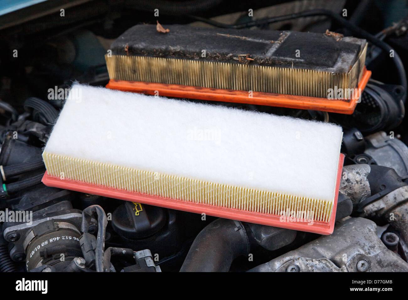dirty air filter with replacement clean new filter in a car engine