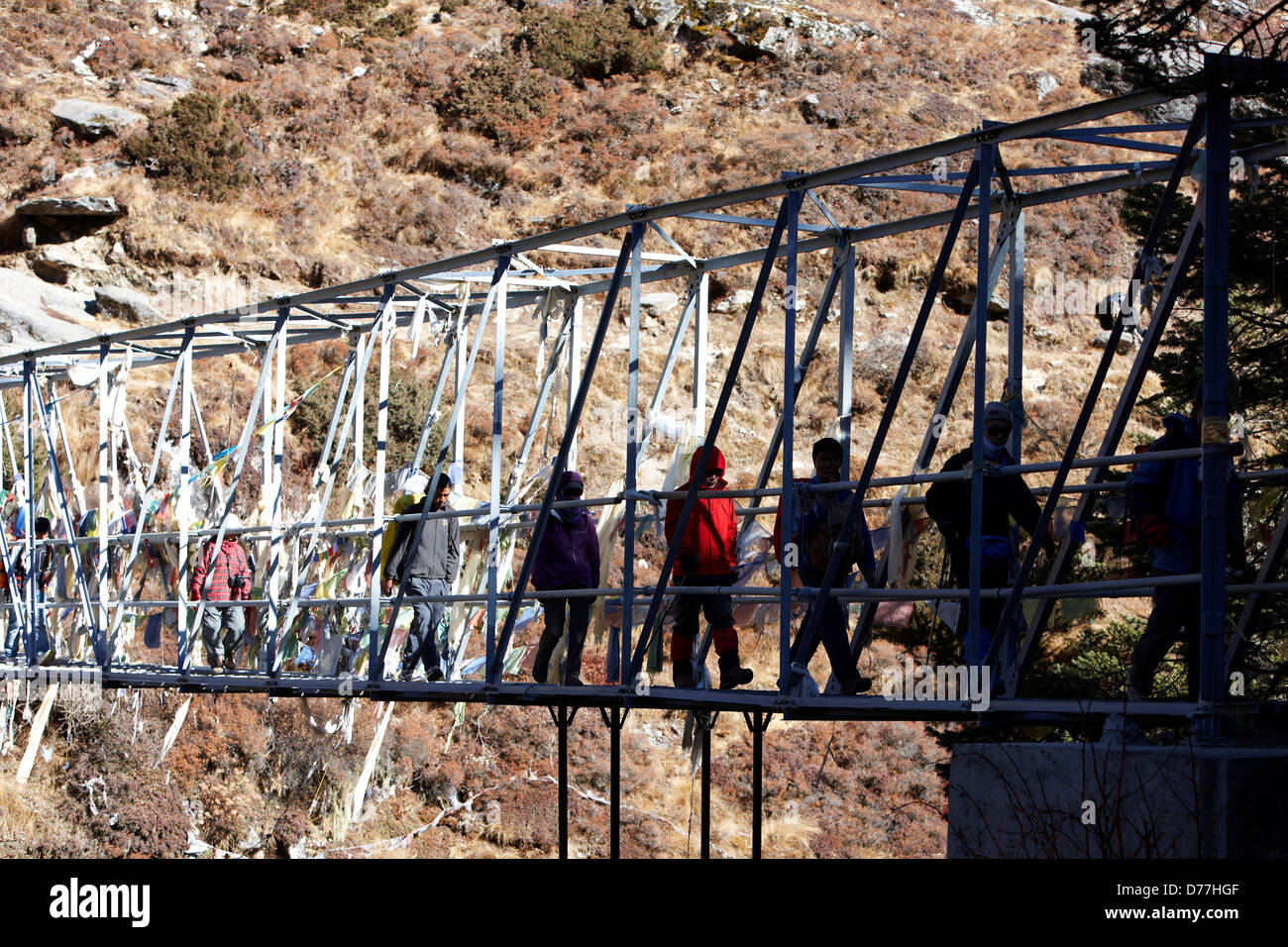 Trekkers crossing suspension bridge hi-res stock photography and images ...