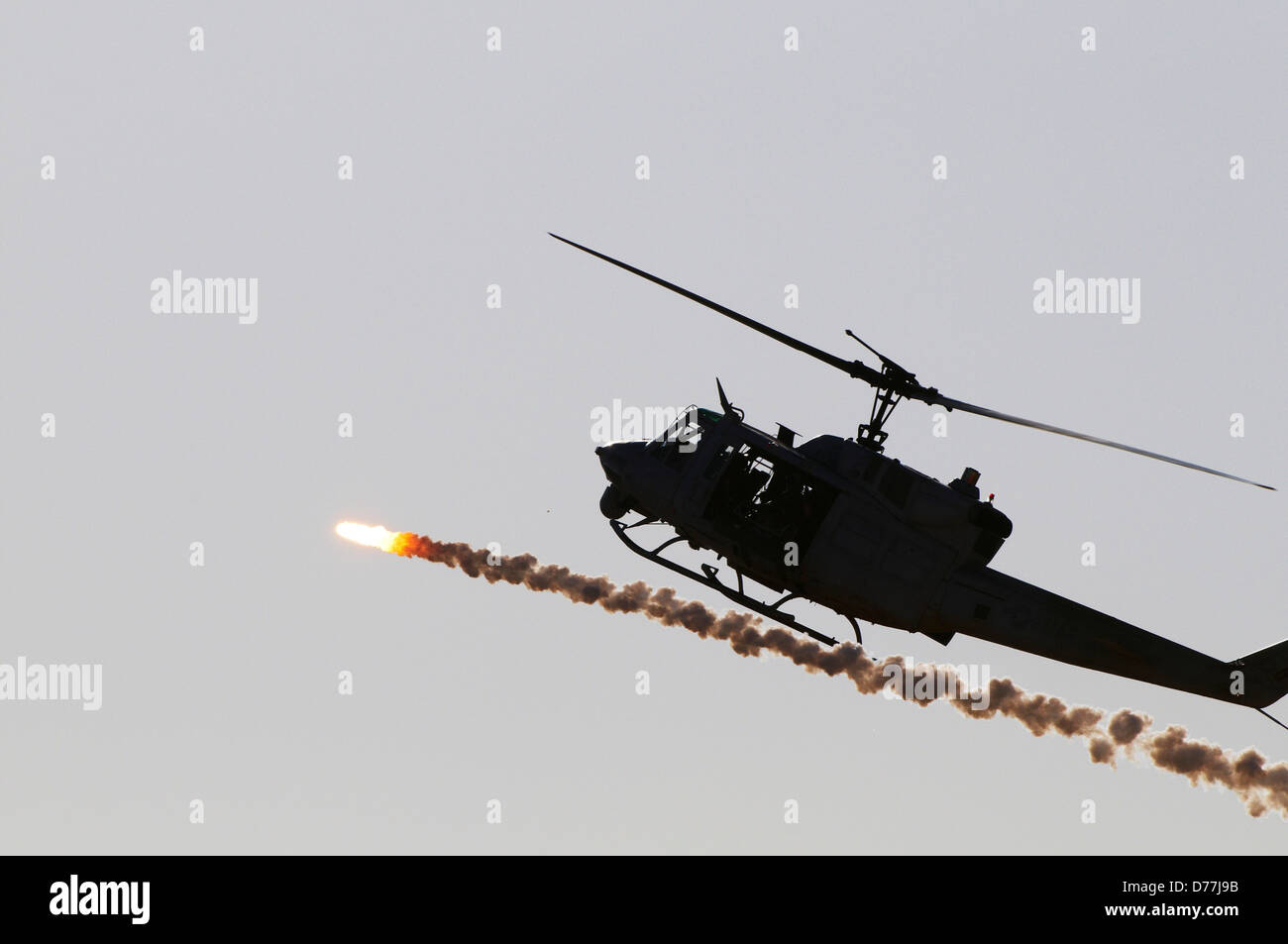 US Marine Corps UH-1N Iroquois Helicopter expends flare during military training exercise Chocolate Mountain Aerial Gunnery Stock Photo