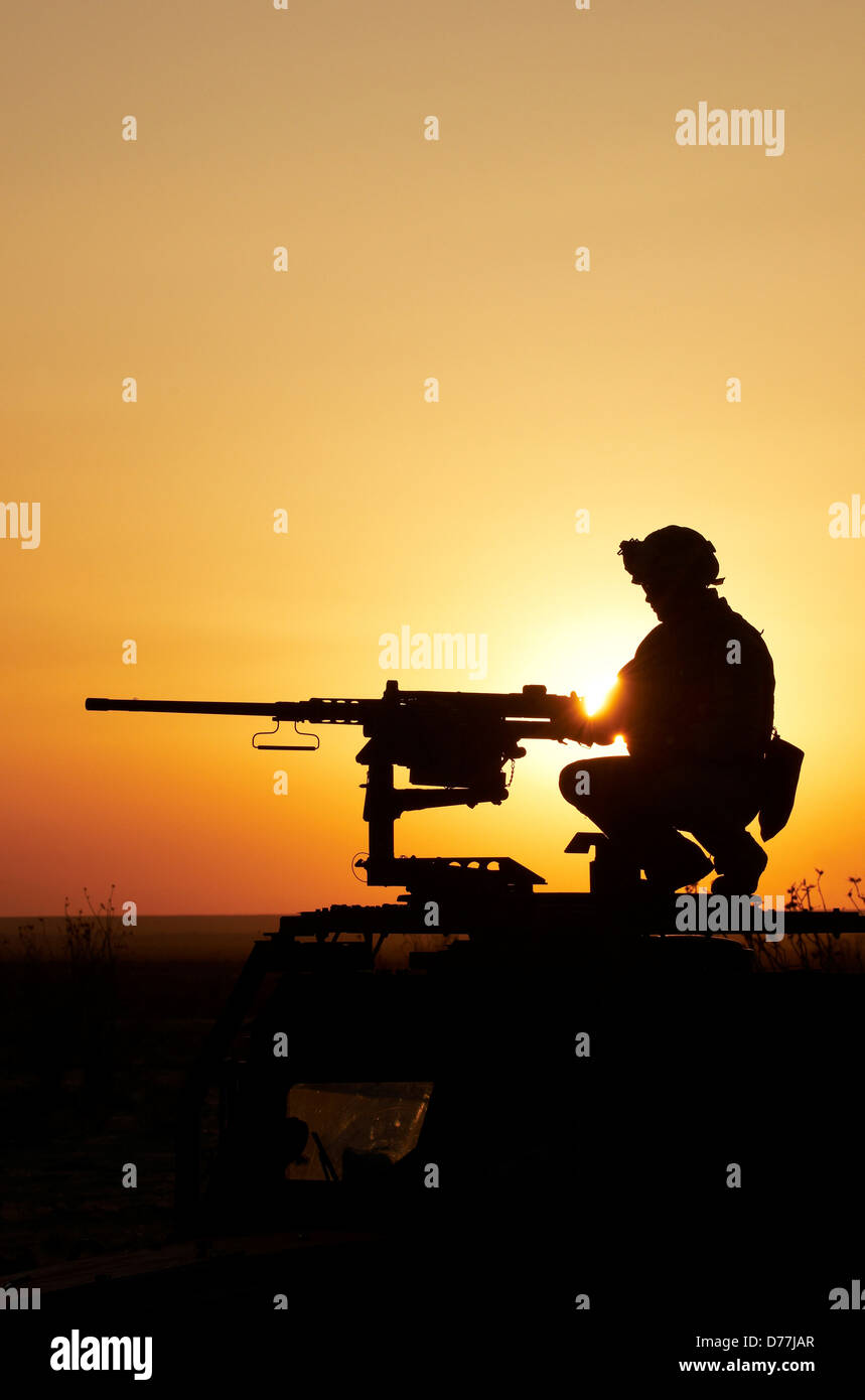 Silhouette US Marine manning M2 .50 caliber machine gun Stock Photo