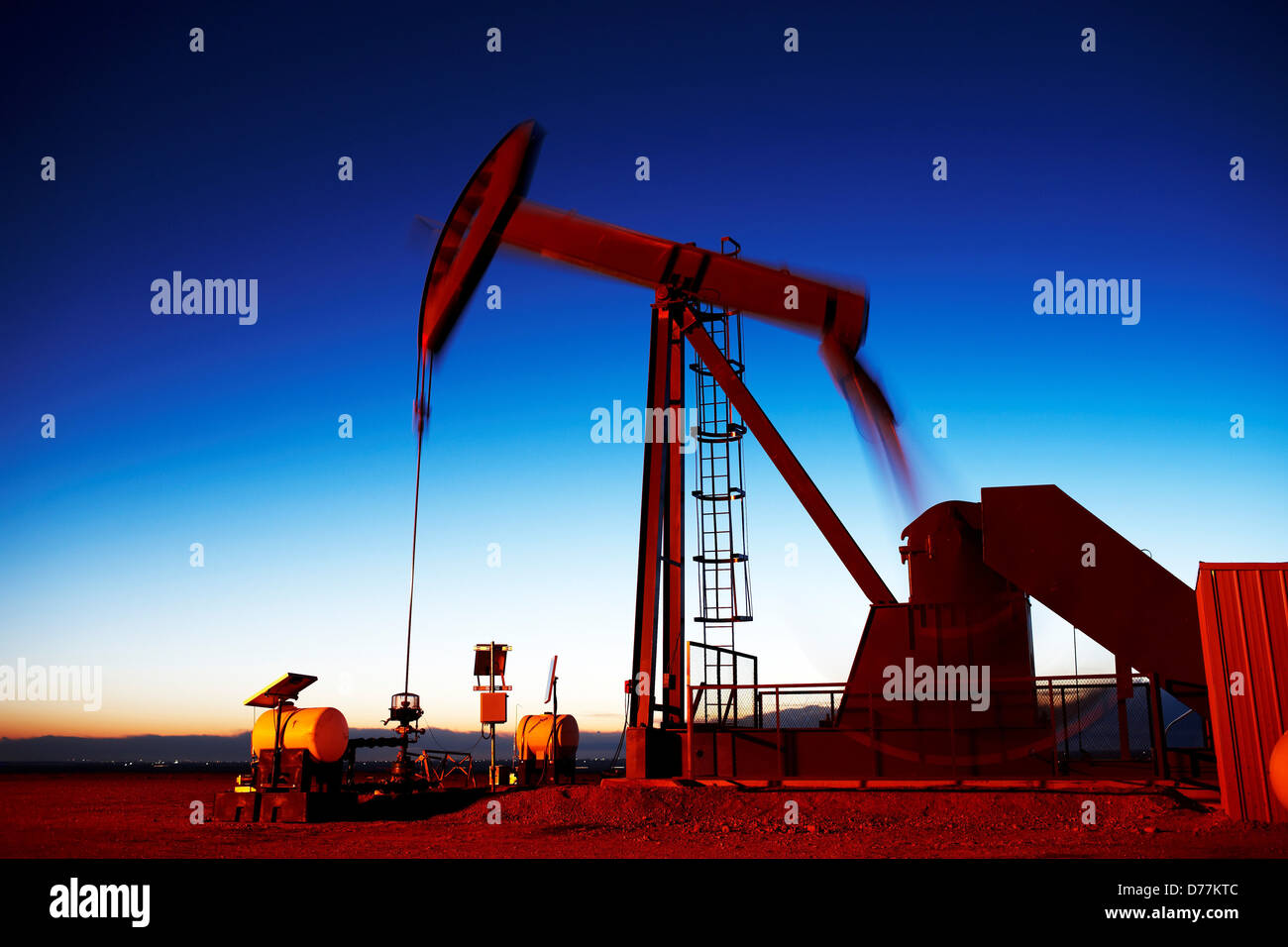 Oil well pumpjack pump jack eastern plains Colorado dusk view Oil well developed hydraulic fracturing also known as Stock Photo