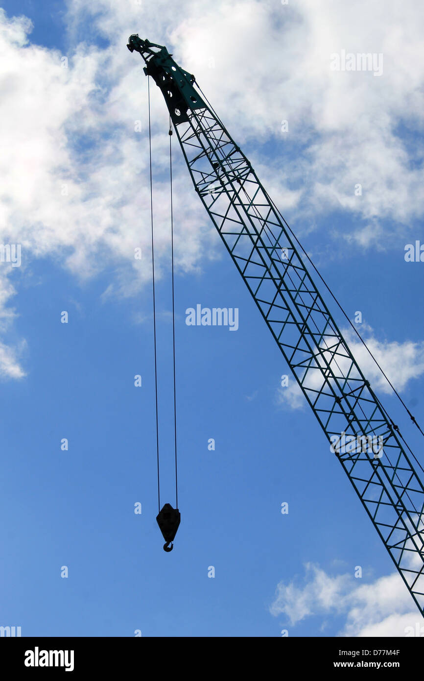Silihouetted crane with blue sky and cloudscape background. Stock Photo