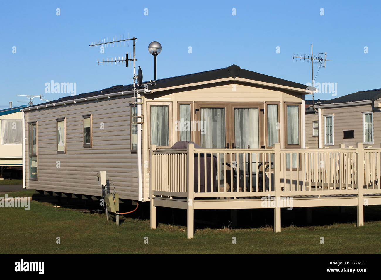 Scenic view of trailers in caravan park with blue sky background. Stock Photo