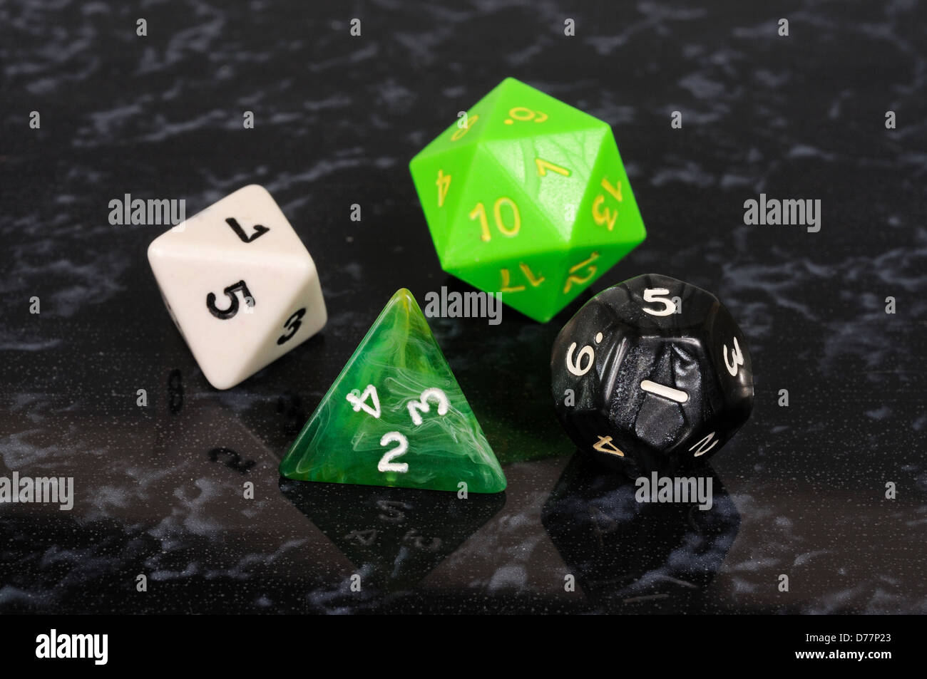 Platonic dice selection against a black background. Stock Photo