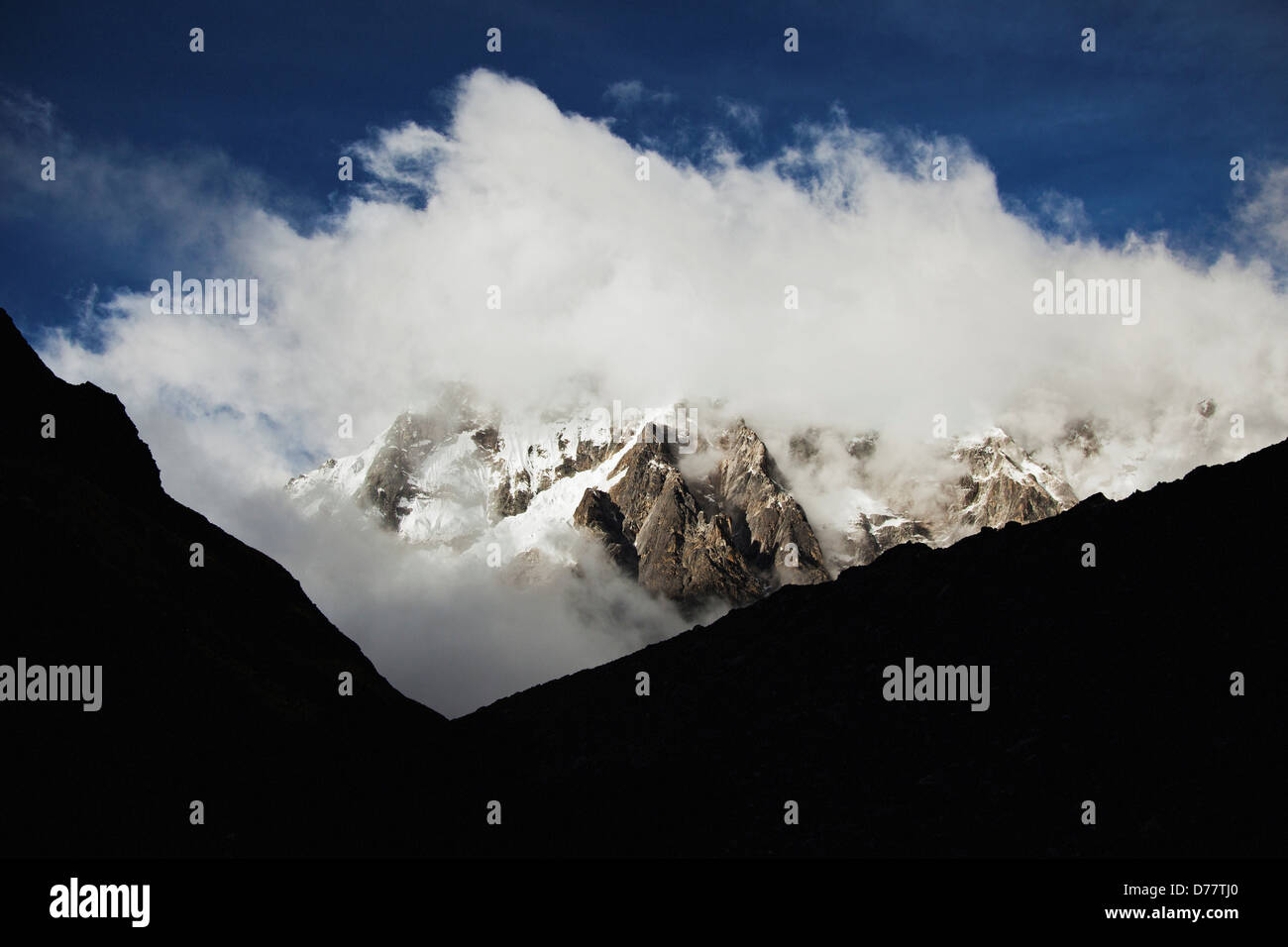 Clouds Wrap Around Jagged Mountain Peaks Along Salkantay Trail in Peru Stock Photo