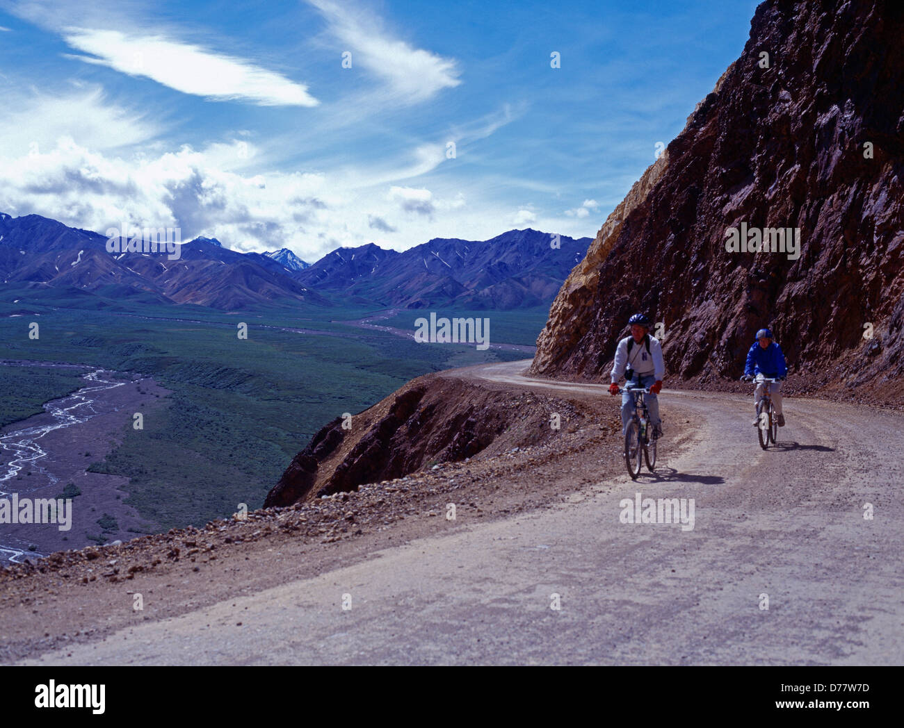 Couple mountain biking park road over Polychrome Pass Denali National Park Alaska. Stock Photo