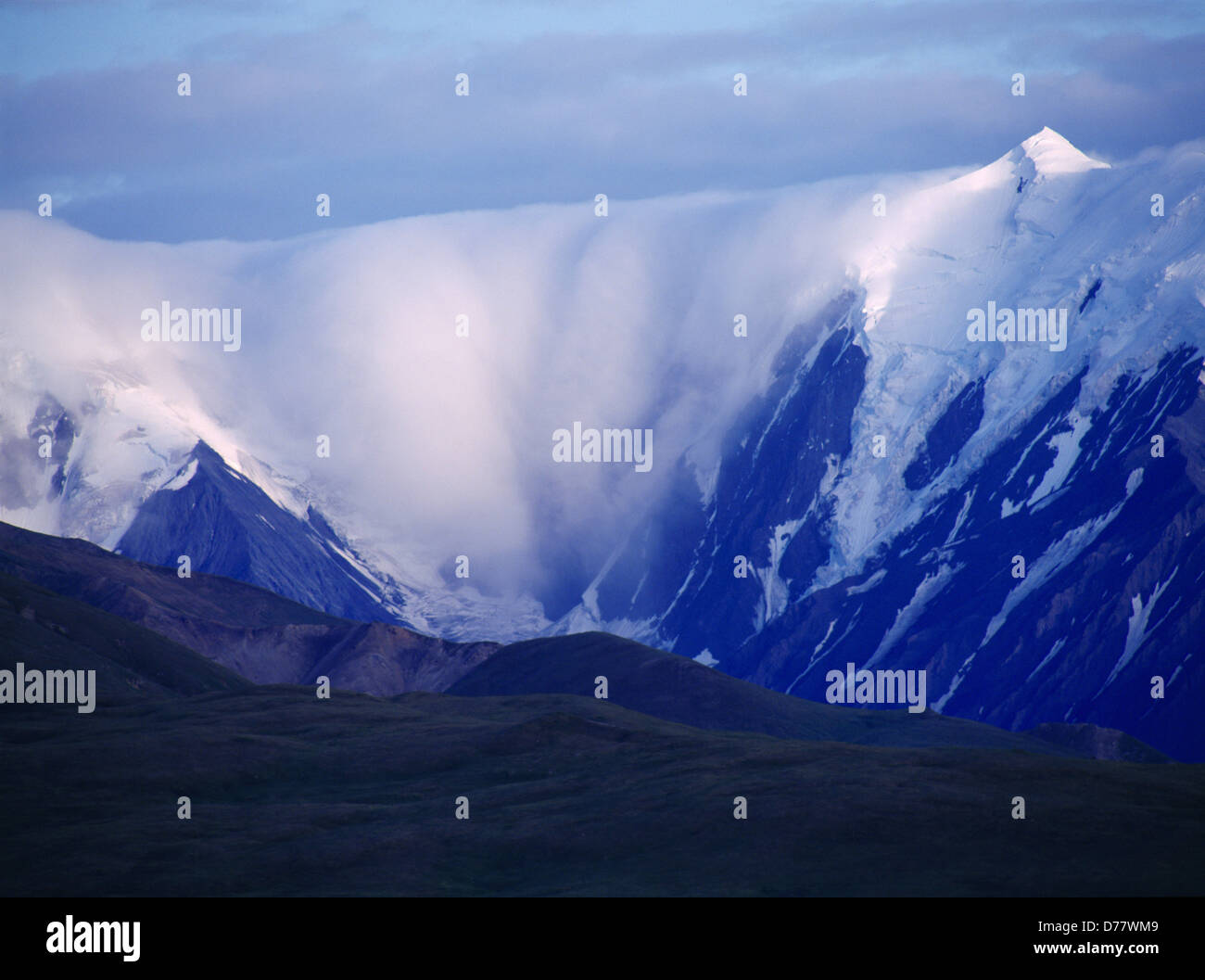 Cloud niagra spilling over Alaska Range Denali National Park Alaska. Stock Photo