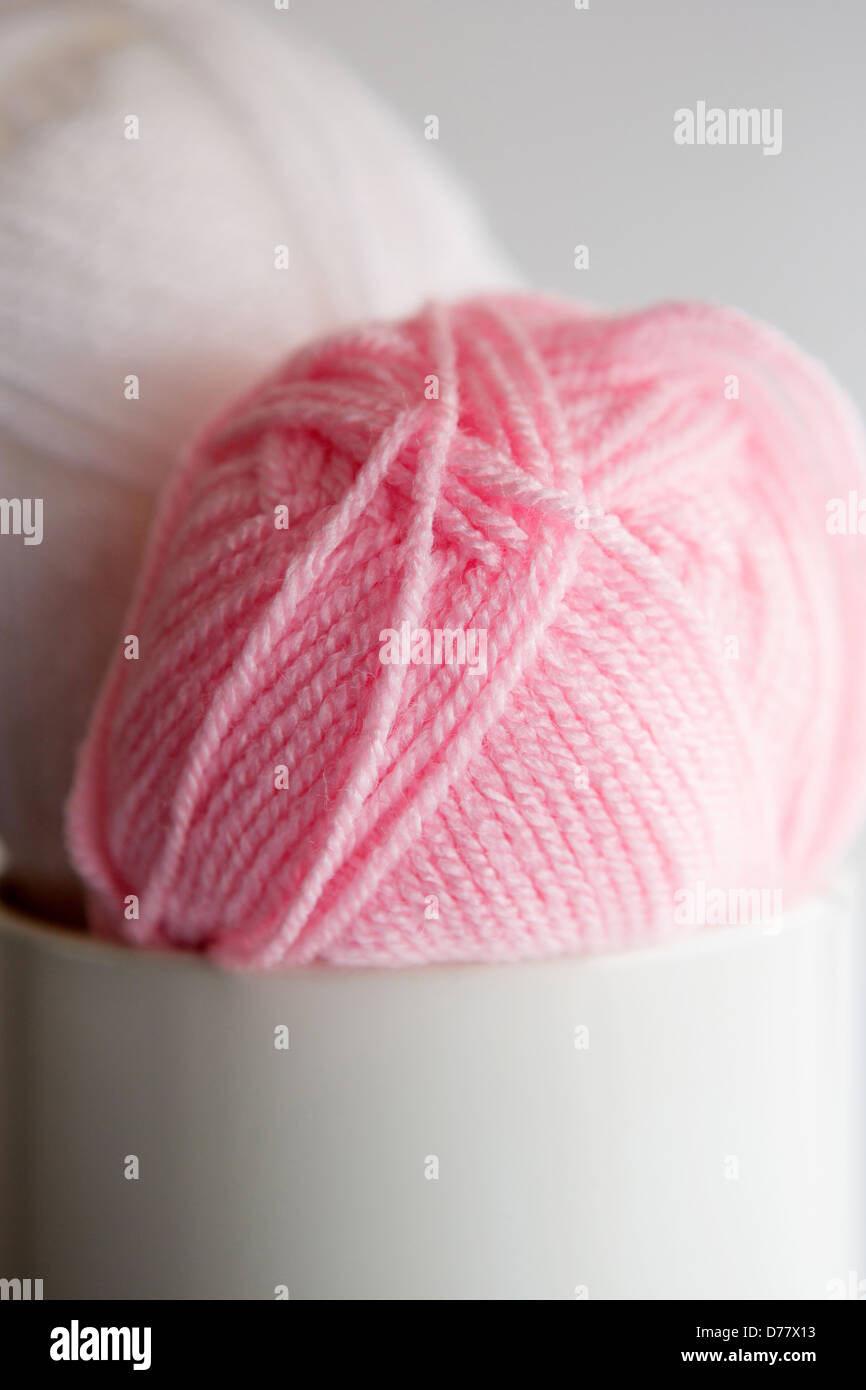 Two balls of wool placed in a tin Stock Photo