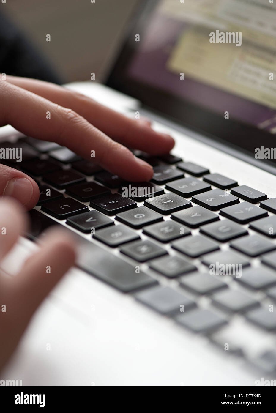 A close up of young person using a laptop Stock Photo - Alamy