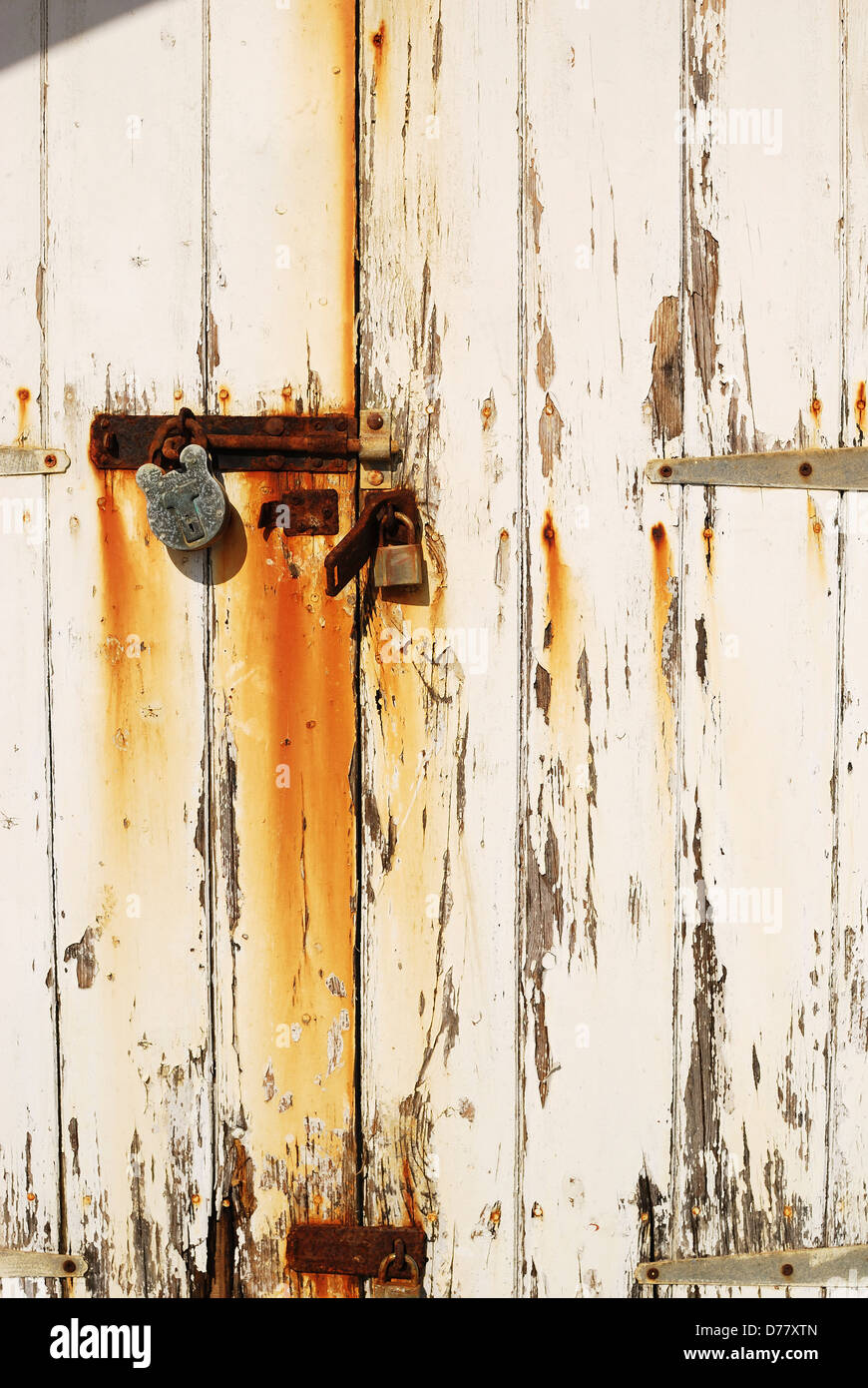 Rusty locks on door to beach hut at Rustington. West Sussex. England Stock Photo