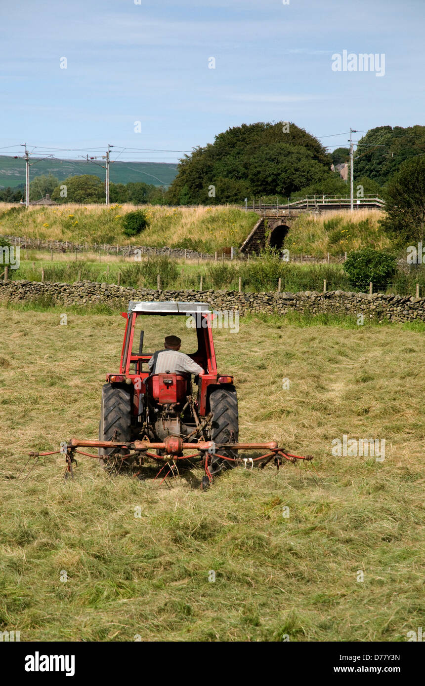 farmer turning the hay for drying with tractor,cumbria,uk Stock Photo Alamy