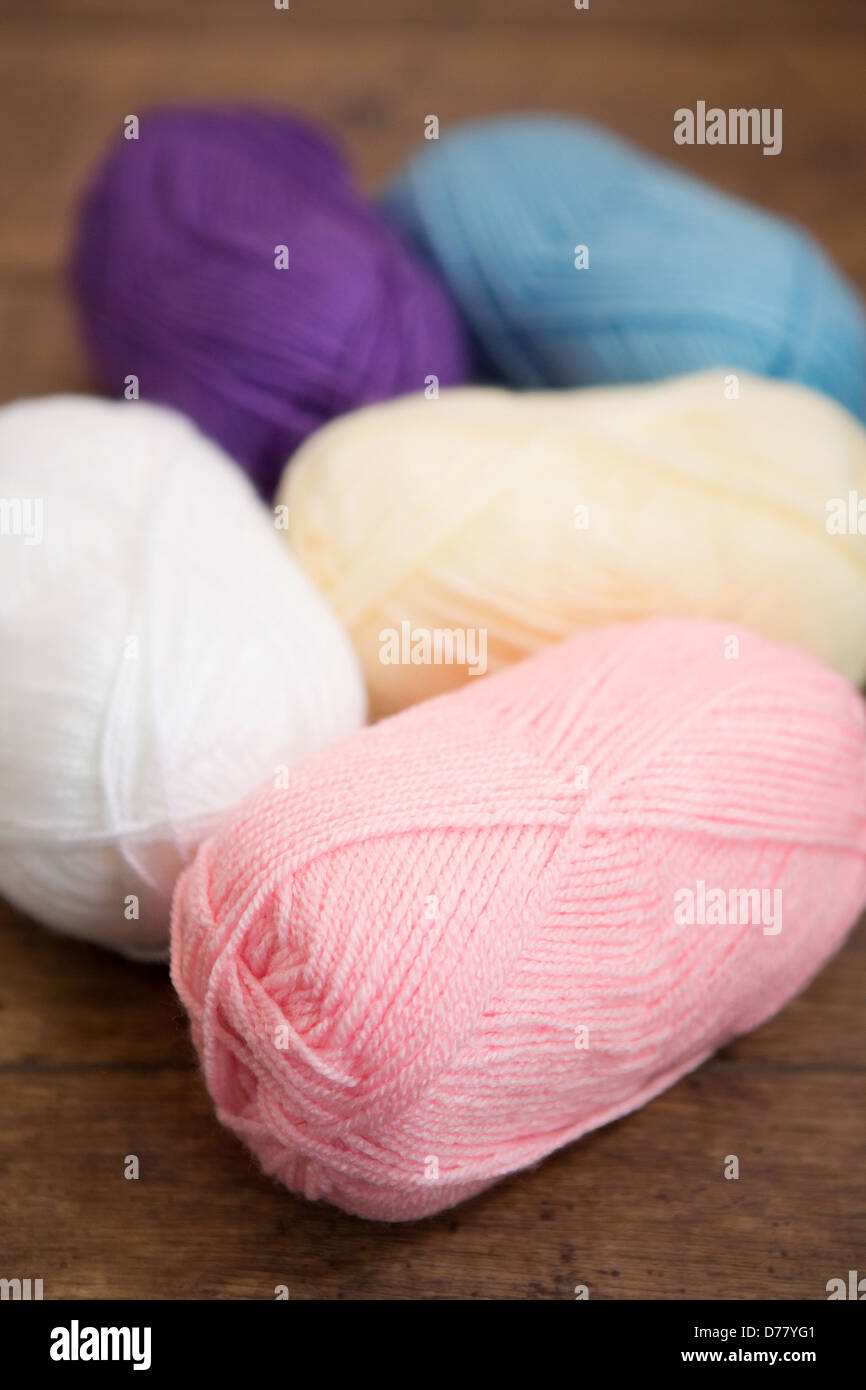 Five balls of wool placed on a wooden background Stock Photo