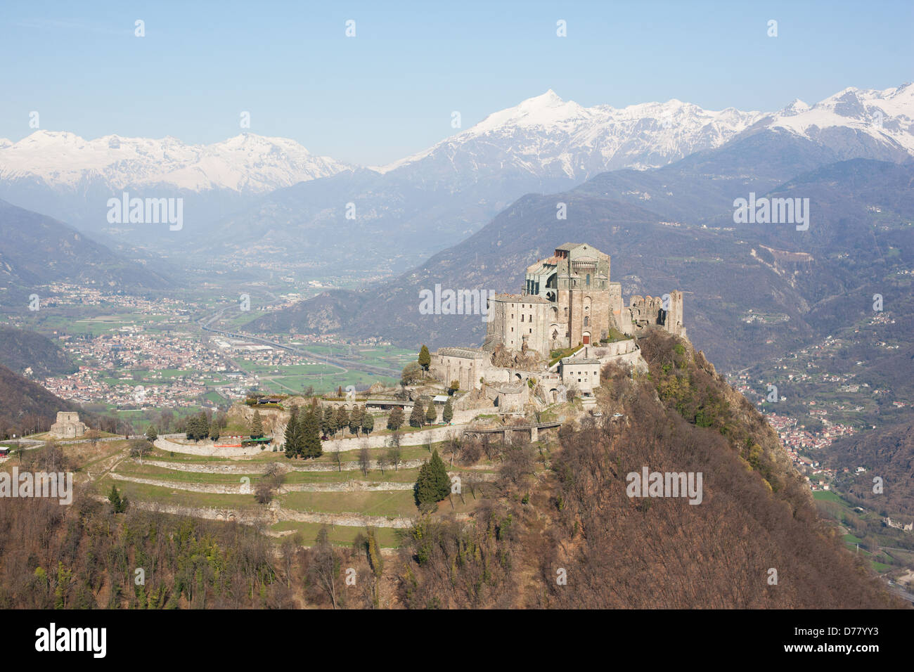 AERIAL VIEW. Abbey on a rocky promontory, high above the Susa Valley. Sacra di San Michele, Metropolitan City of Turin, Piedmont, Italy. Stock Photo