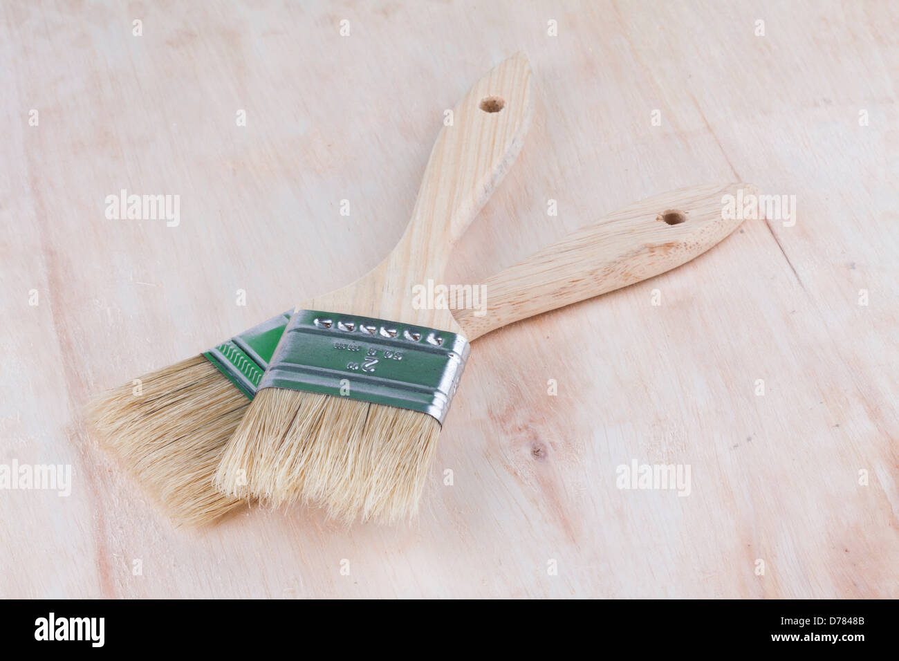 two paint brush with wood background and space for text Stock Photo - Alamy
