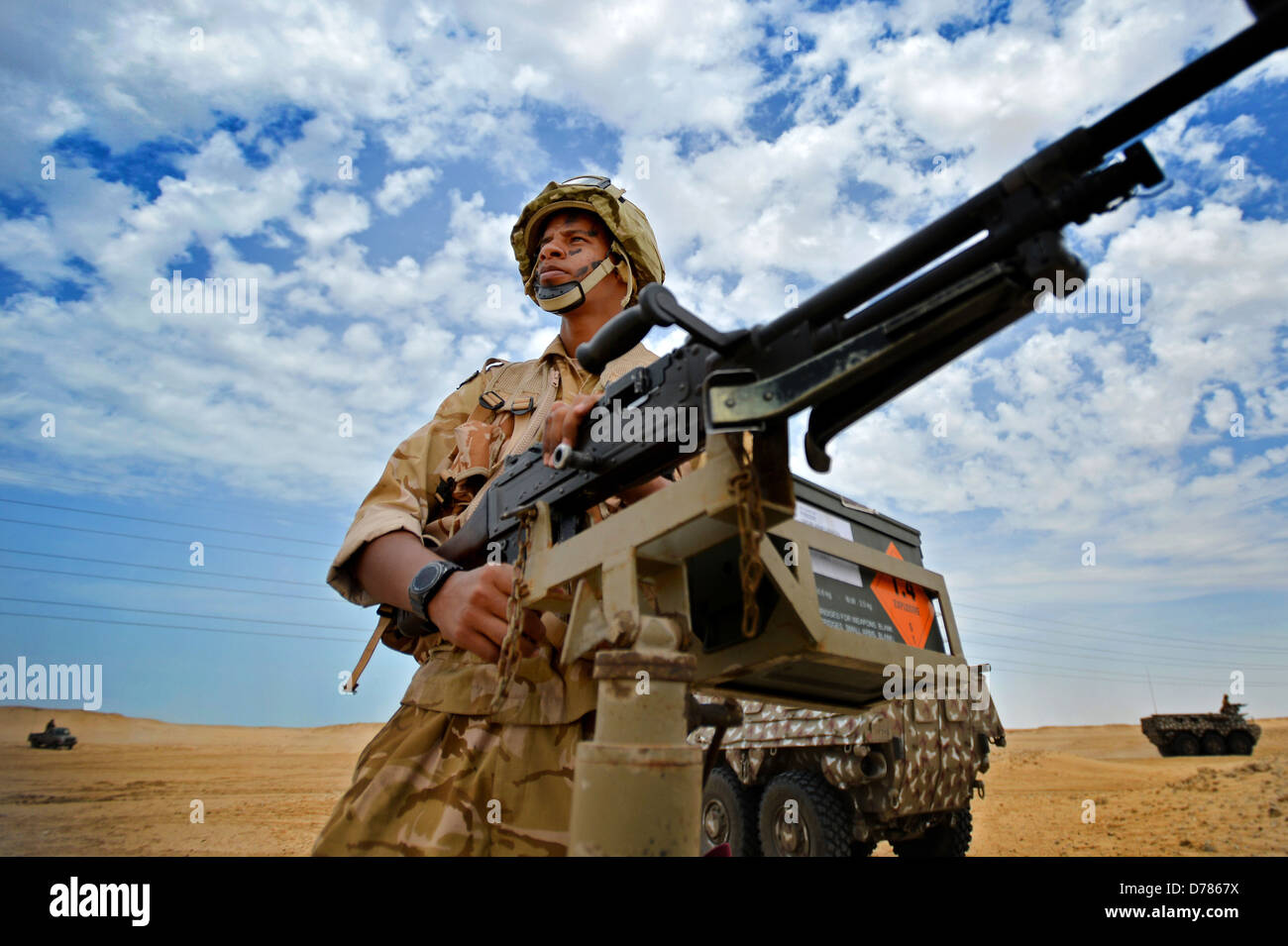 A Qatar Armed Forces soldier mans a heavy machine gun in the bed of a truck as his unit prepares for a joint counter-terrorism exercise April 28, 2013 in Zikrit, Qatar. Stock Photo