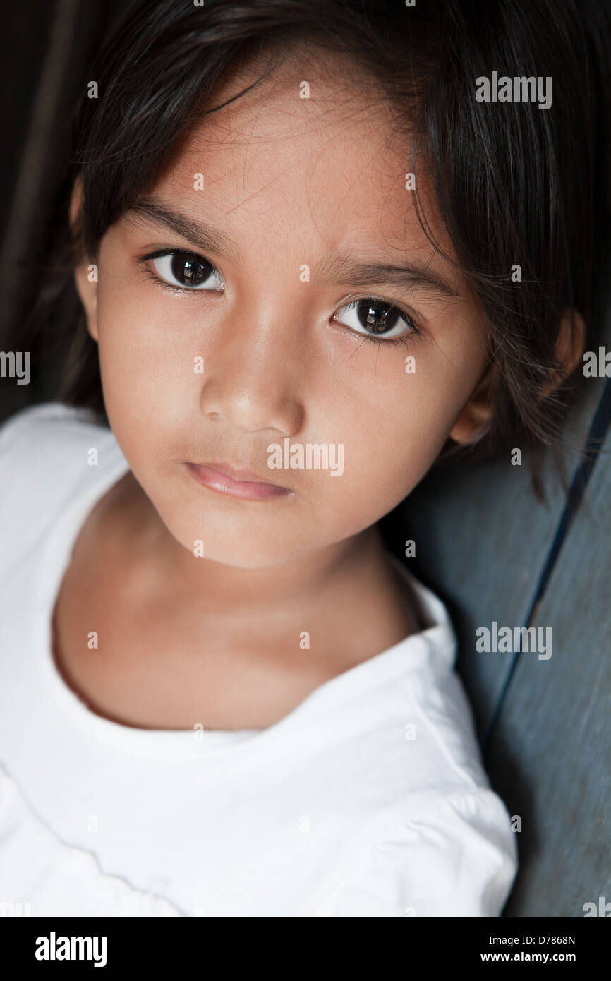 Portrait of a pretty young girl from the Philippines against a wall Stock Photo