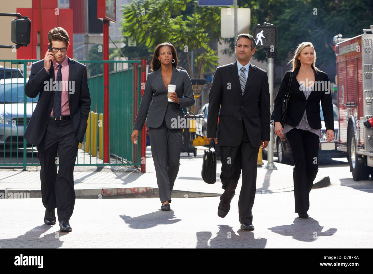 Group Of Businesspeople Crossing Street Stock Photo