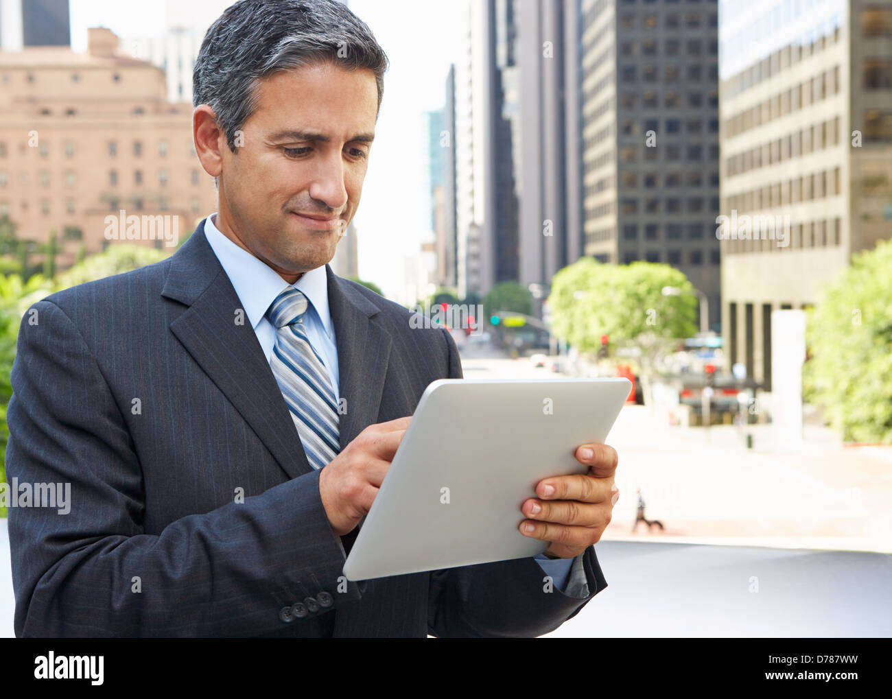 Businessman Working On Tablet Computer Outside Office Stock Photo - Alamy