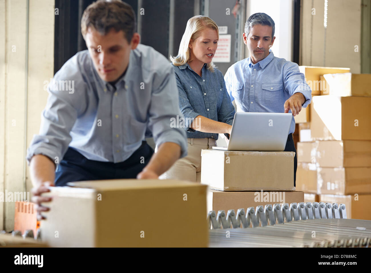 Workers In Distribution Warehouse Stock Photo