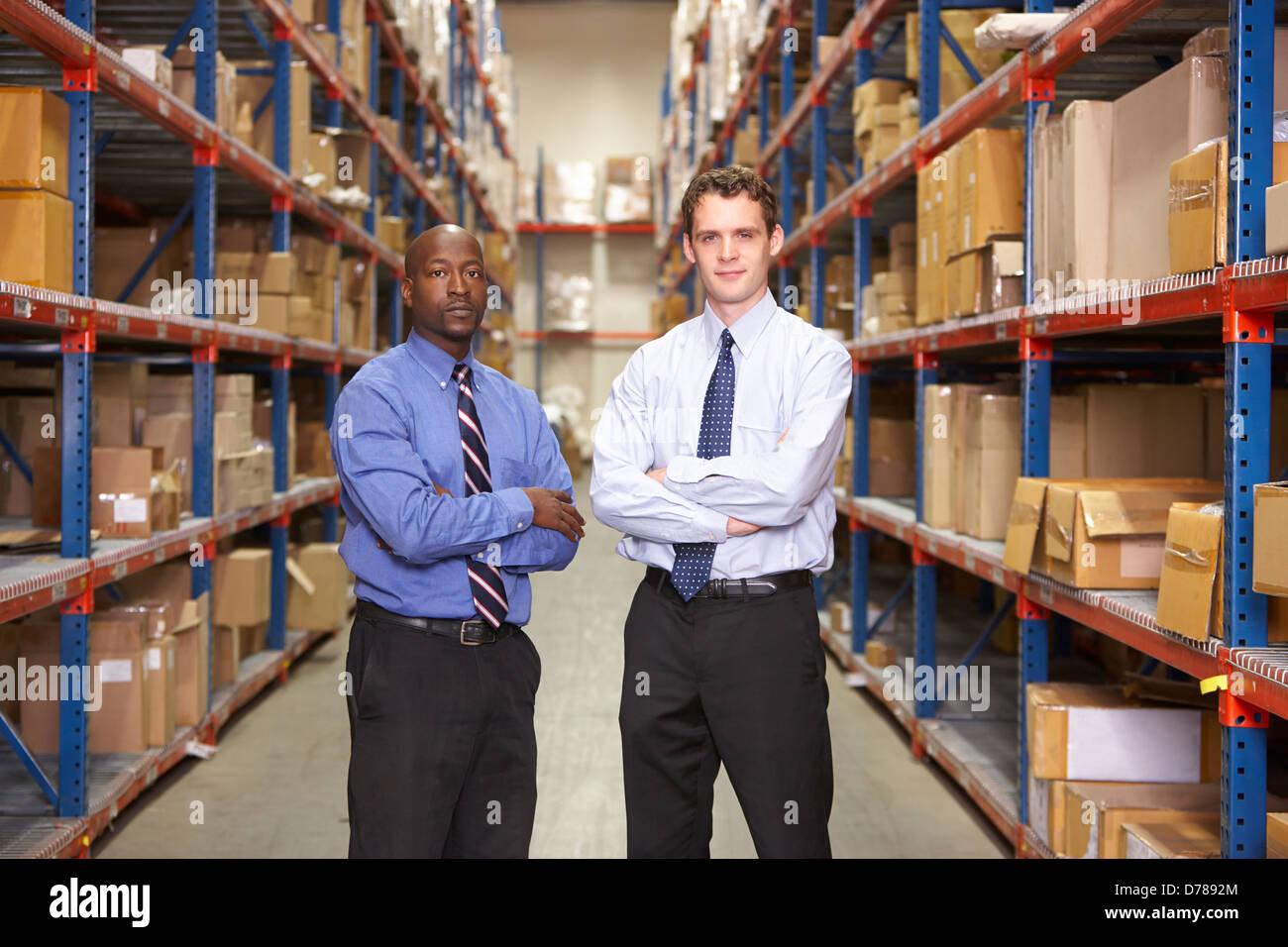 Portrait Of Two Businessmen In Warehouse Stock Photo