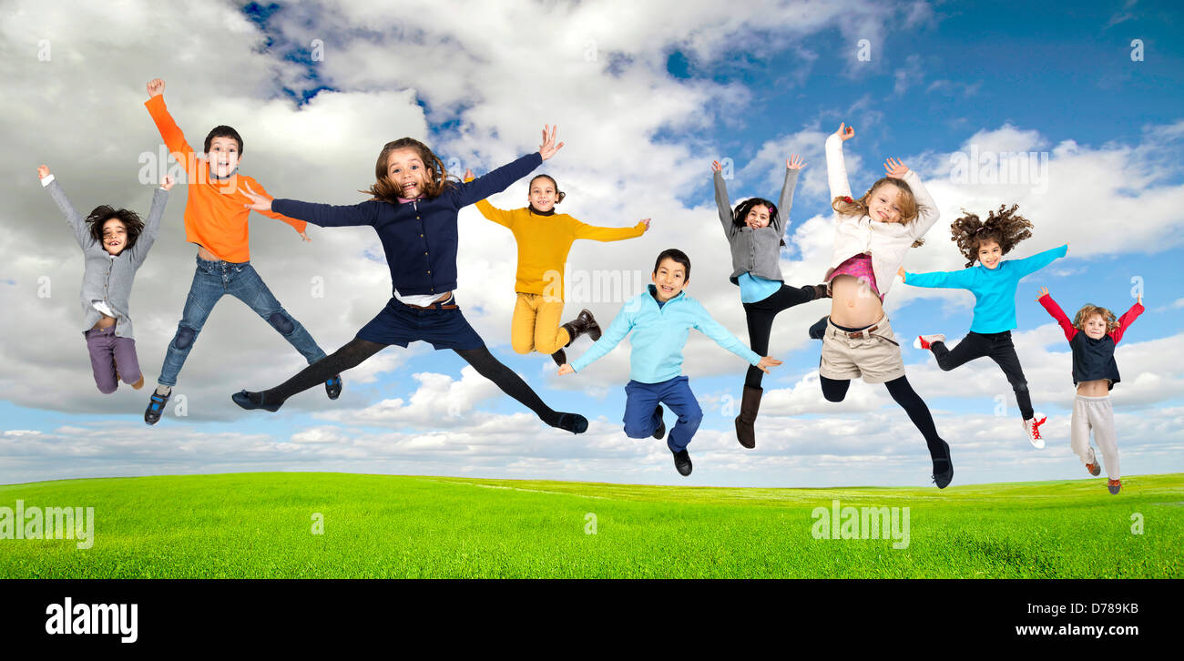 Group of children jumping outdoors Stock Photo - Alamy