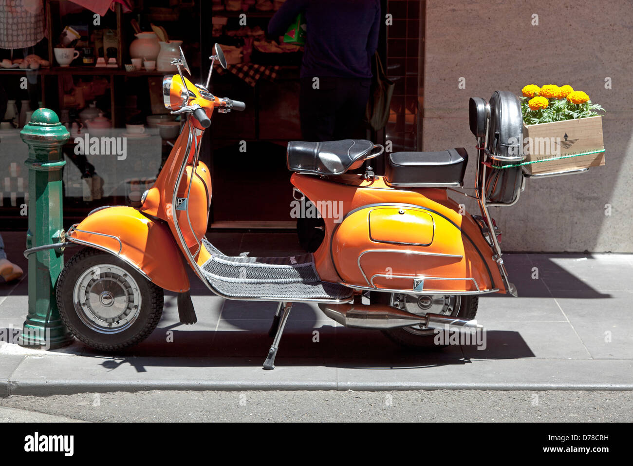 Orange scooter with orange Tagetes, Melbourne, Australia Stock Photo
