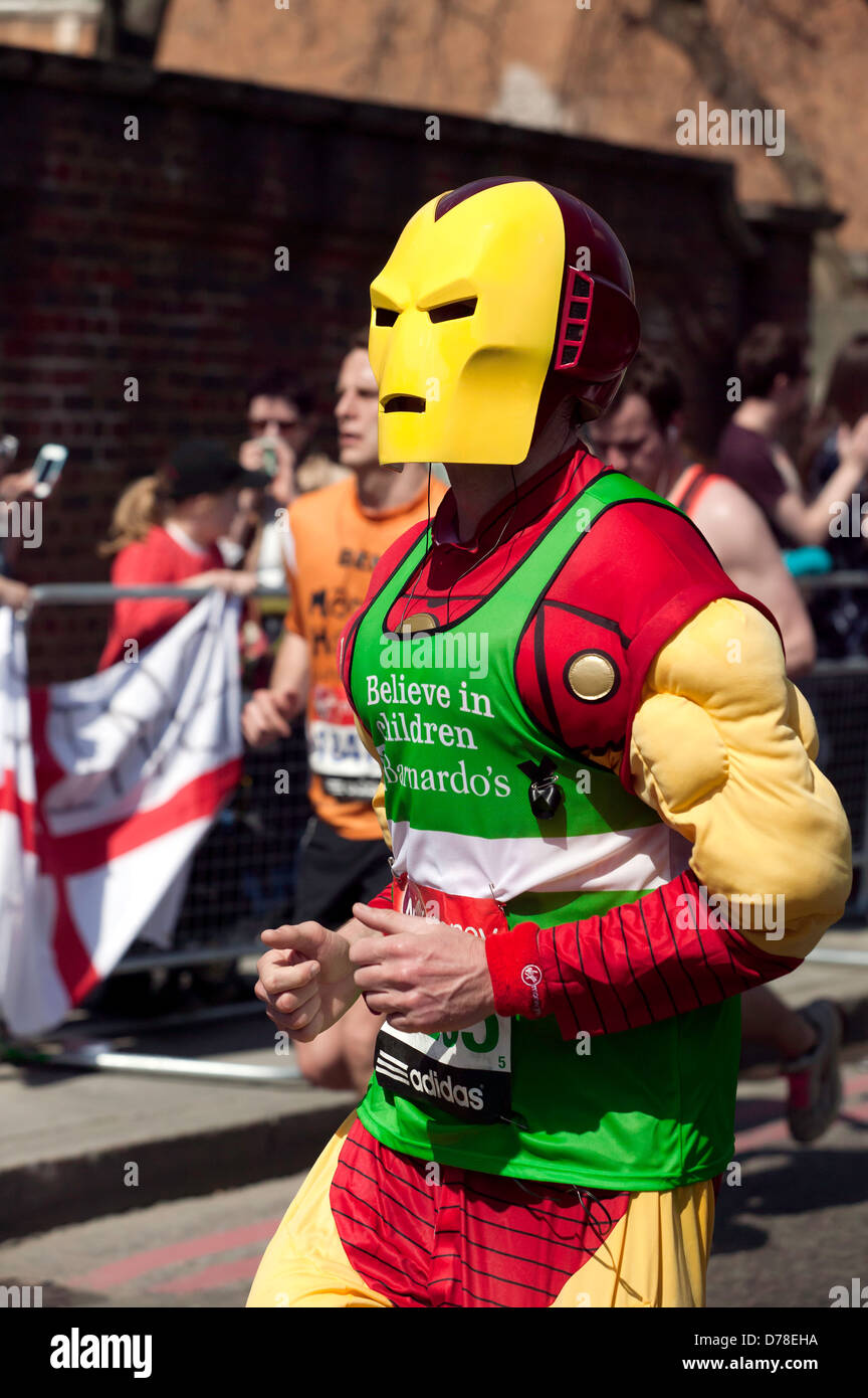 Charity runner dressed in an Iron Man costume, running in the 2013 London Marathon Stock Photo