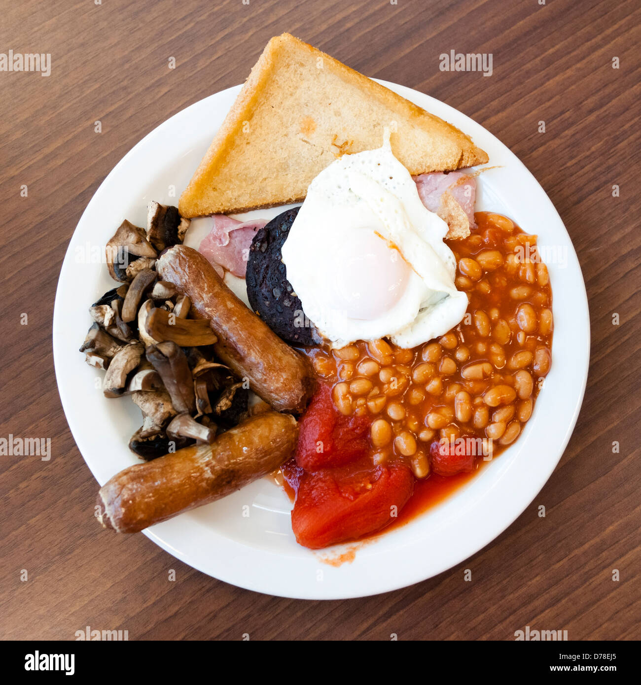 Full English breakfast, with black pudding fry up at a cafe. Fried breakfast overhead food UK. Stock Photo