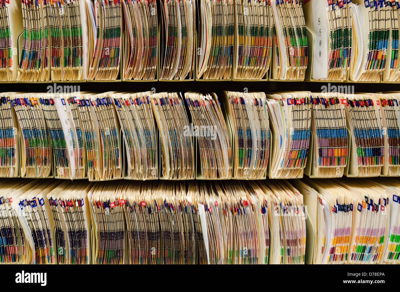 Shelves filled with colorfully labeled medical files Stock Photo Alamy