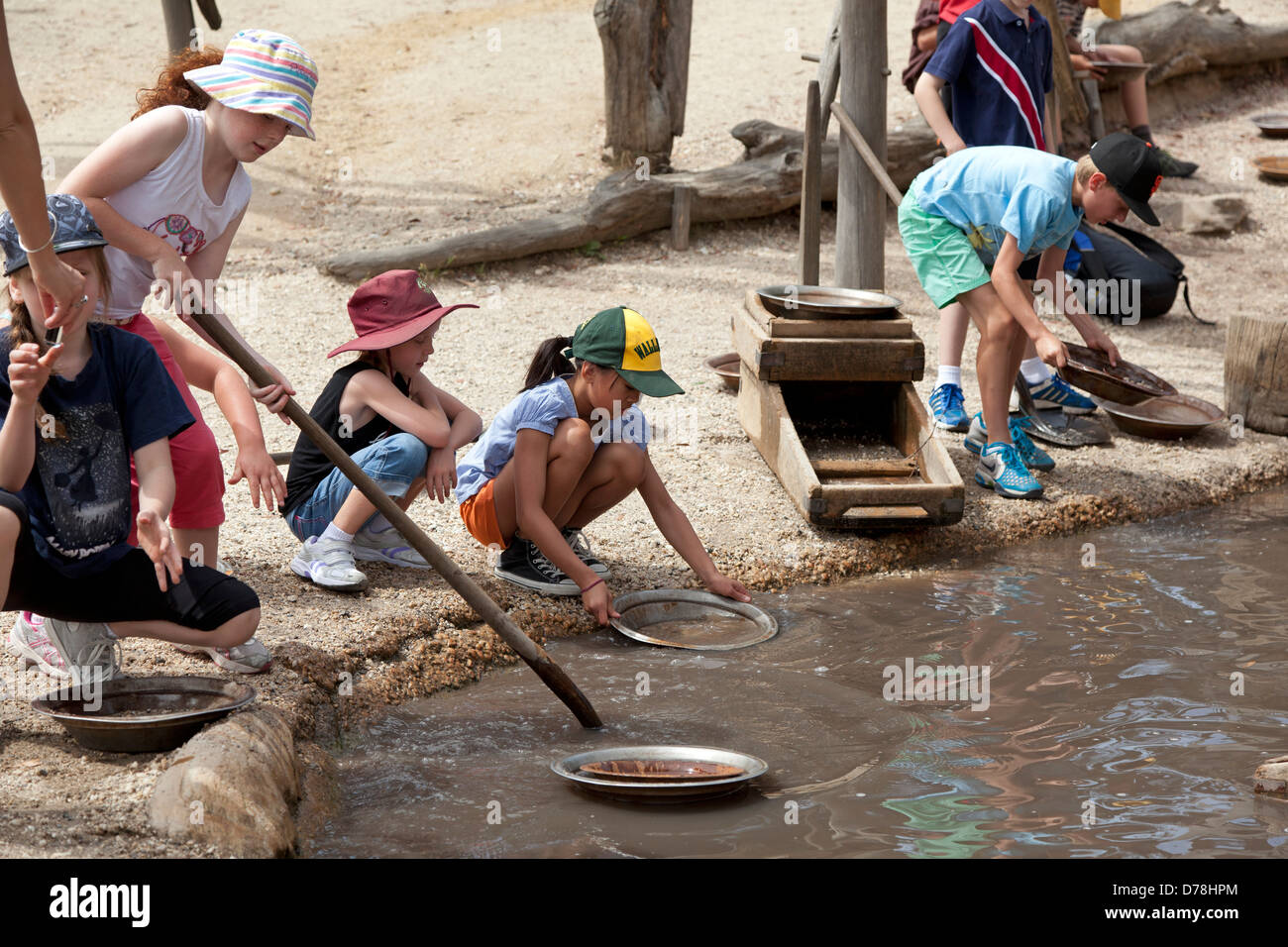 Children pan for gold at Sovereign Hill's former gold mining site in Ballarat, Australia Stock Photo