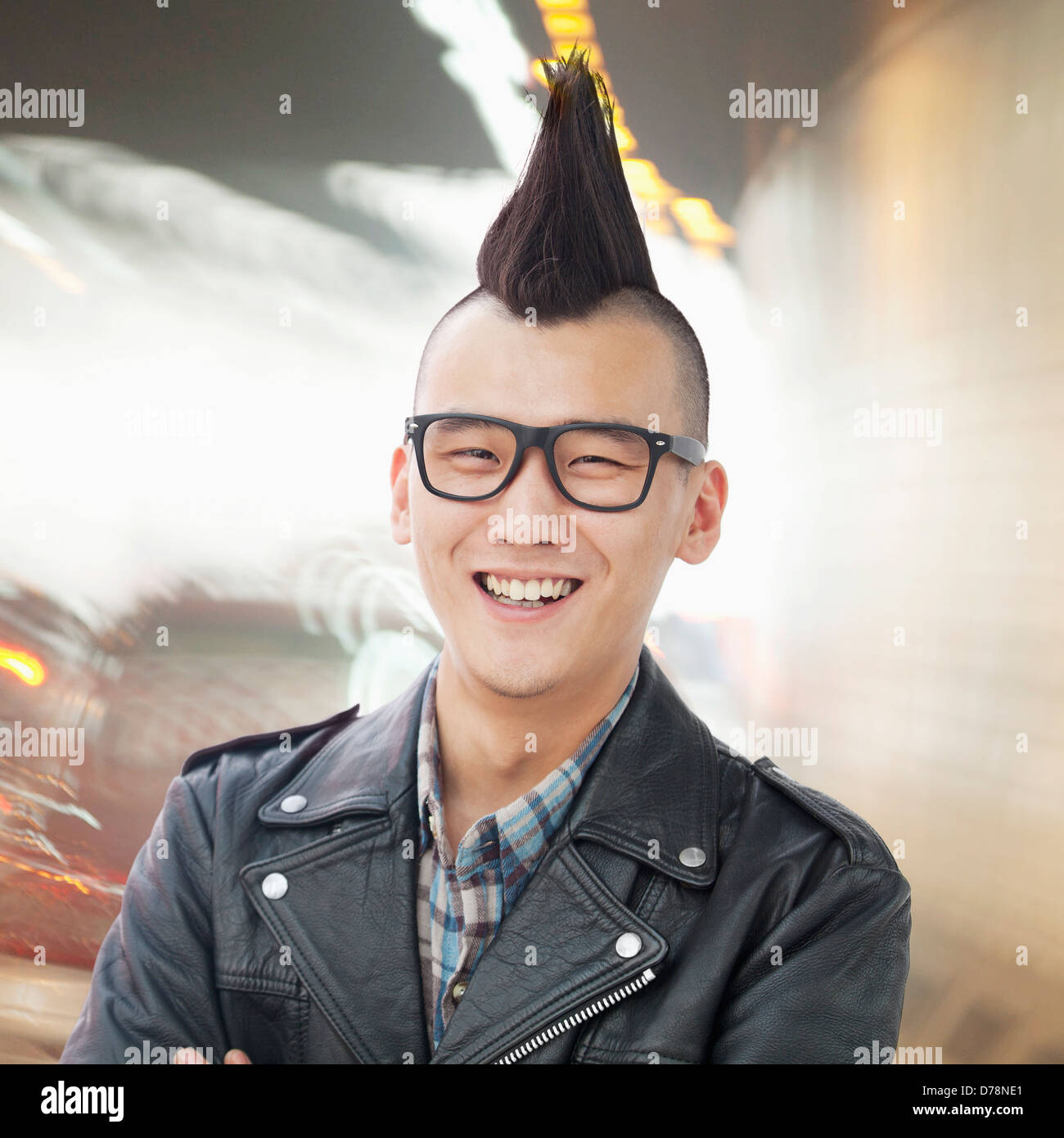 Young man with punk Mohawk smiling Stock Photo