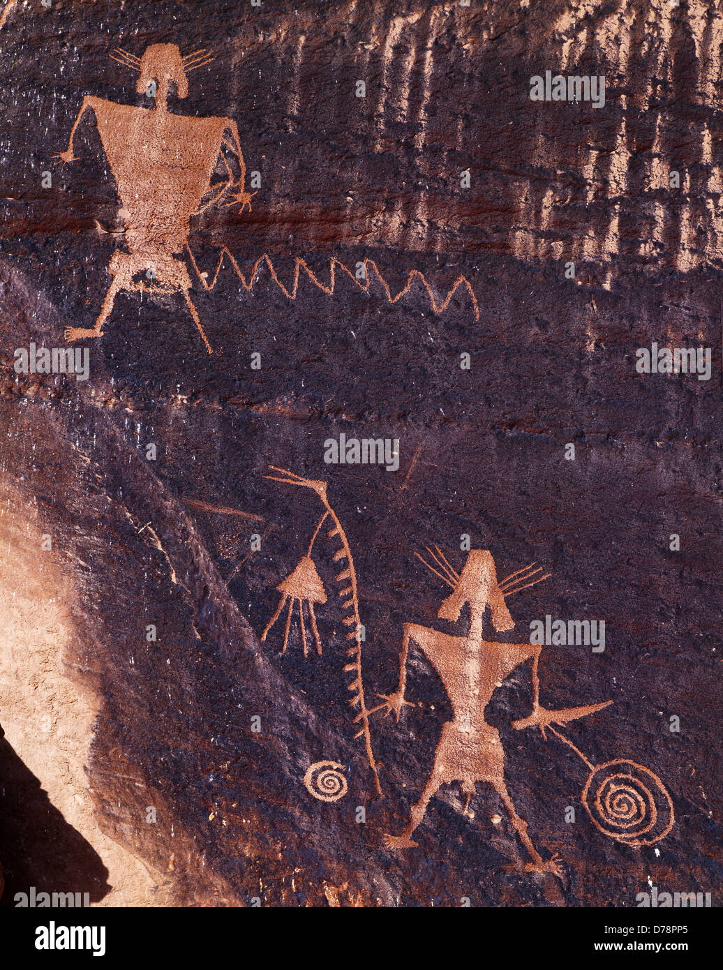 Fremont petroglyphs anthropomorphs including individual holding bird-headed staff western Colorado. Stock Photo