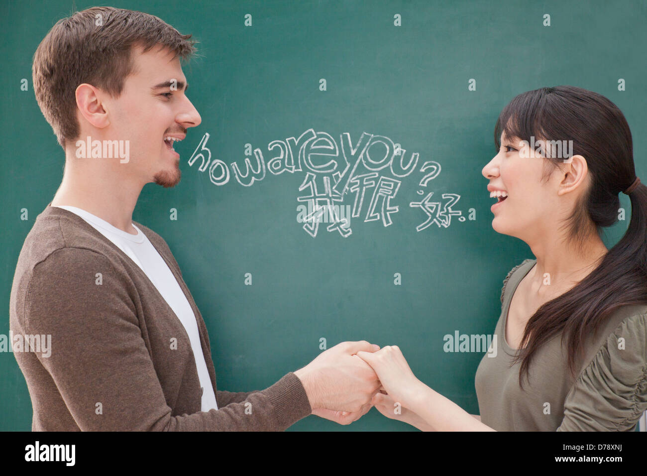 Portrait of smiling male teacher and student in front of chalkboard ...