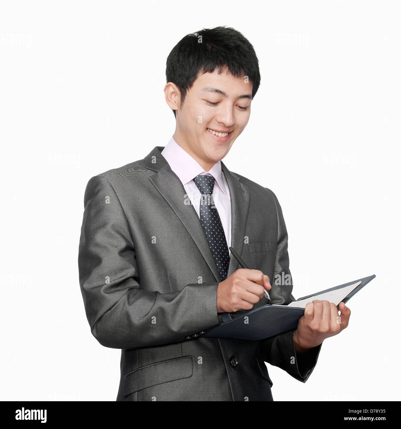 Businessman taking notes in her notebook Stock Photo