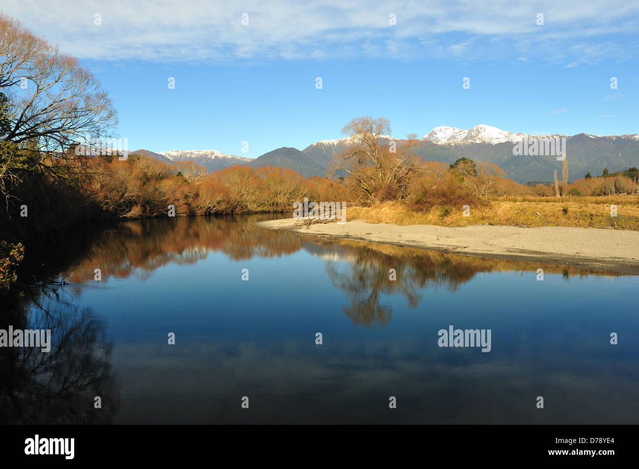 The reflection of the snowy mountains and trees on the river during winter at New Zealand Stock Photo