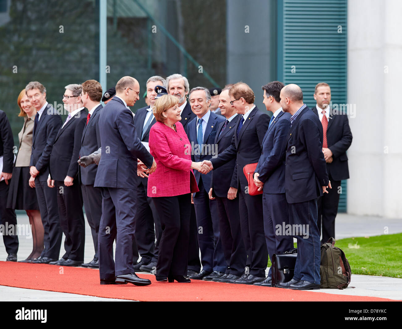 Berlin, Germany. 30th April 2013. Greeting of the Prime Minister of the Italian Republic, Enrico Letta, with military honors by German Chancellor Angela Merkel in the main courtyard of the Federal Chancellery in Berlin. On Picture:  Angela Merkel (CDU), German Chancellor, and Enrico Letta, new Prime Minister of Italia, greats the Federal Ministers fron bouth Country. Credit:  Reynaldo Chaib Paganelli / Alamy Live News Stock Photo