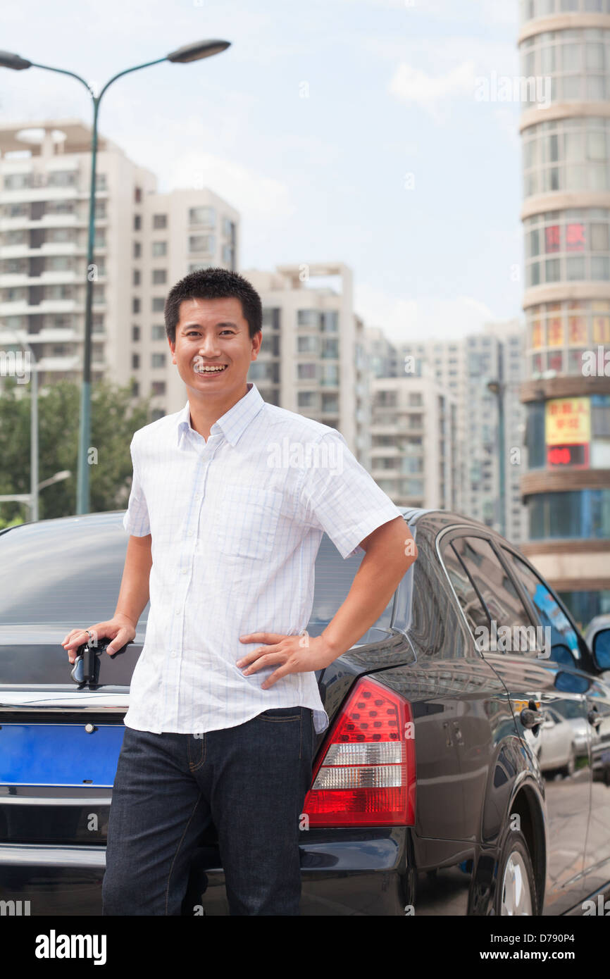 Man standing next to his car Stock Photo - Alamy