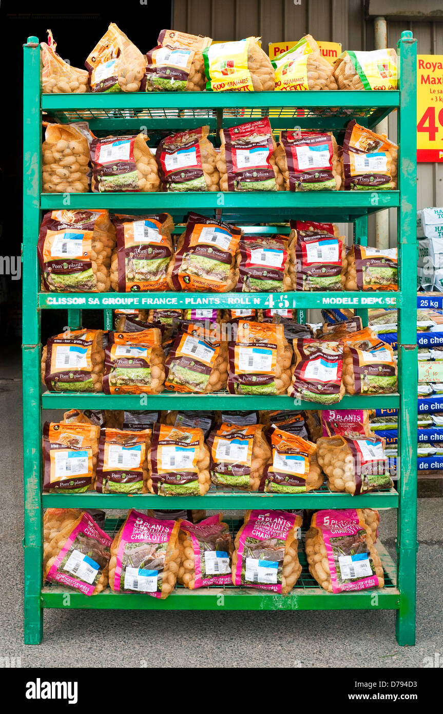 Rack of bags of seed potatoes at garden center - France. Stock Photo