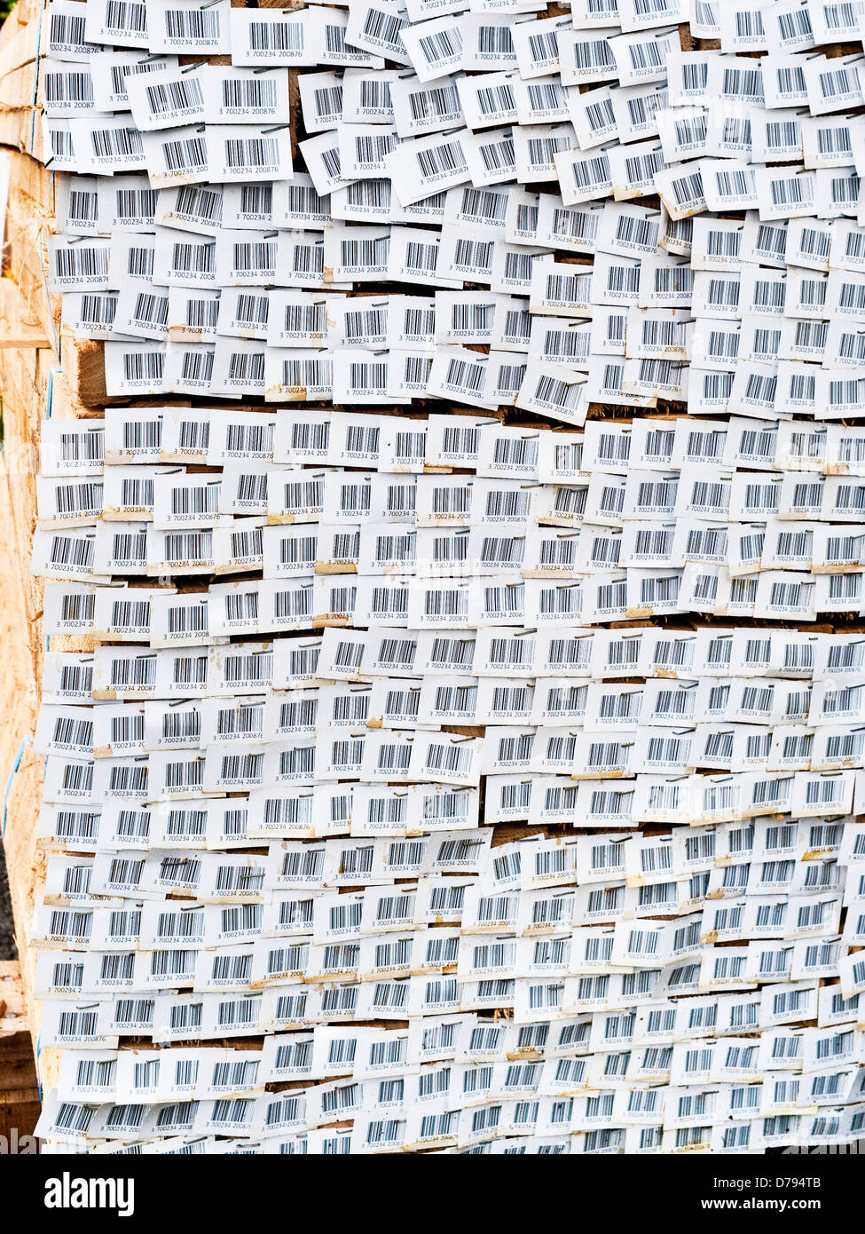 Stack of garden stakes with bar code labels at garden center - France. Stock Photo