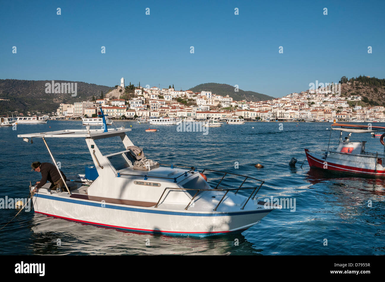 The Island and Town of Poros, seen from the harbour at Galatas, Attica, Peloponnese, Greece. Stock Photo