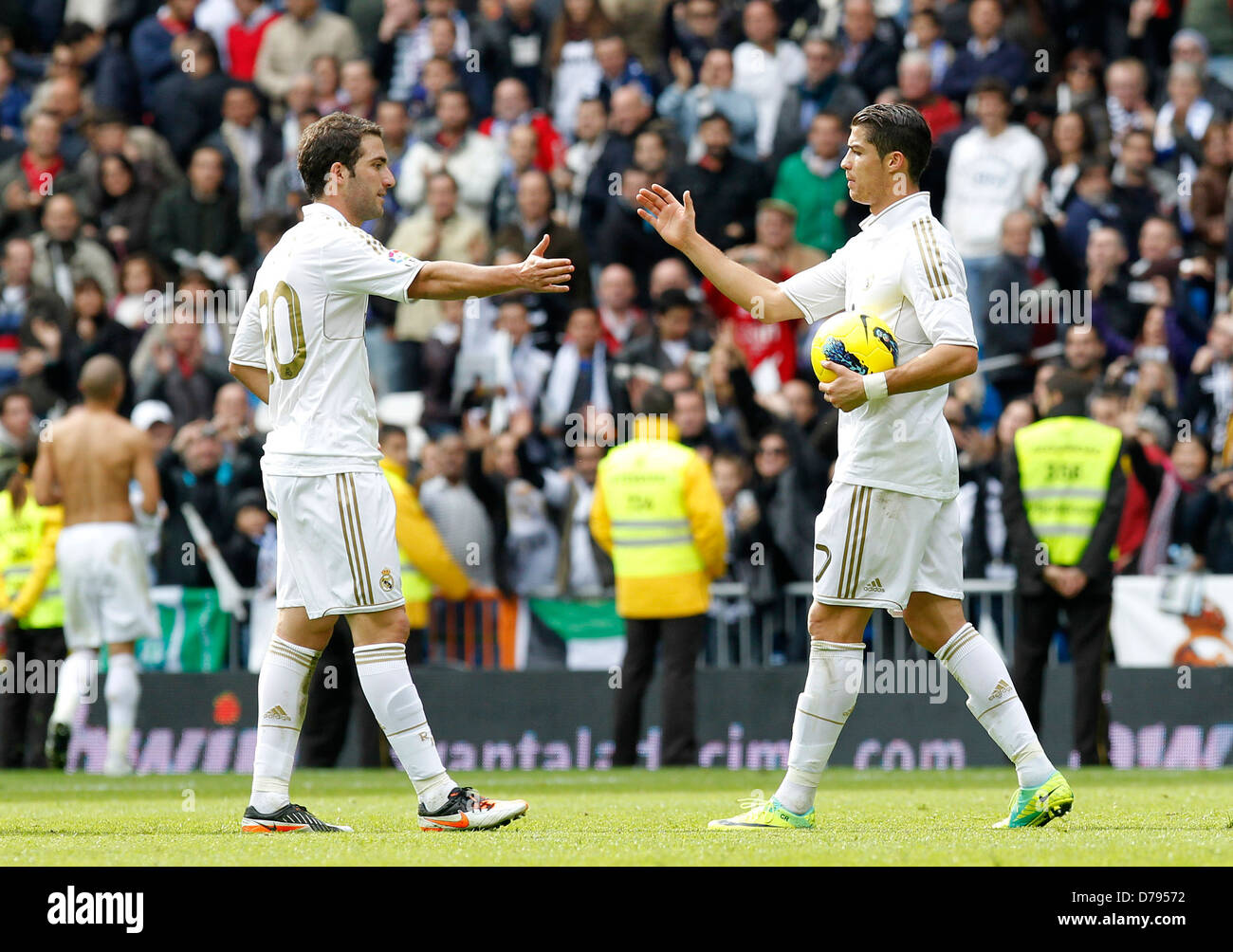 Cristiano Ronaldo is congratulated by teammate Gonzalo Higuain on scoring a hat-trick Real Madrid Vs. Osasuna held at Santiago Stock Photo