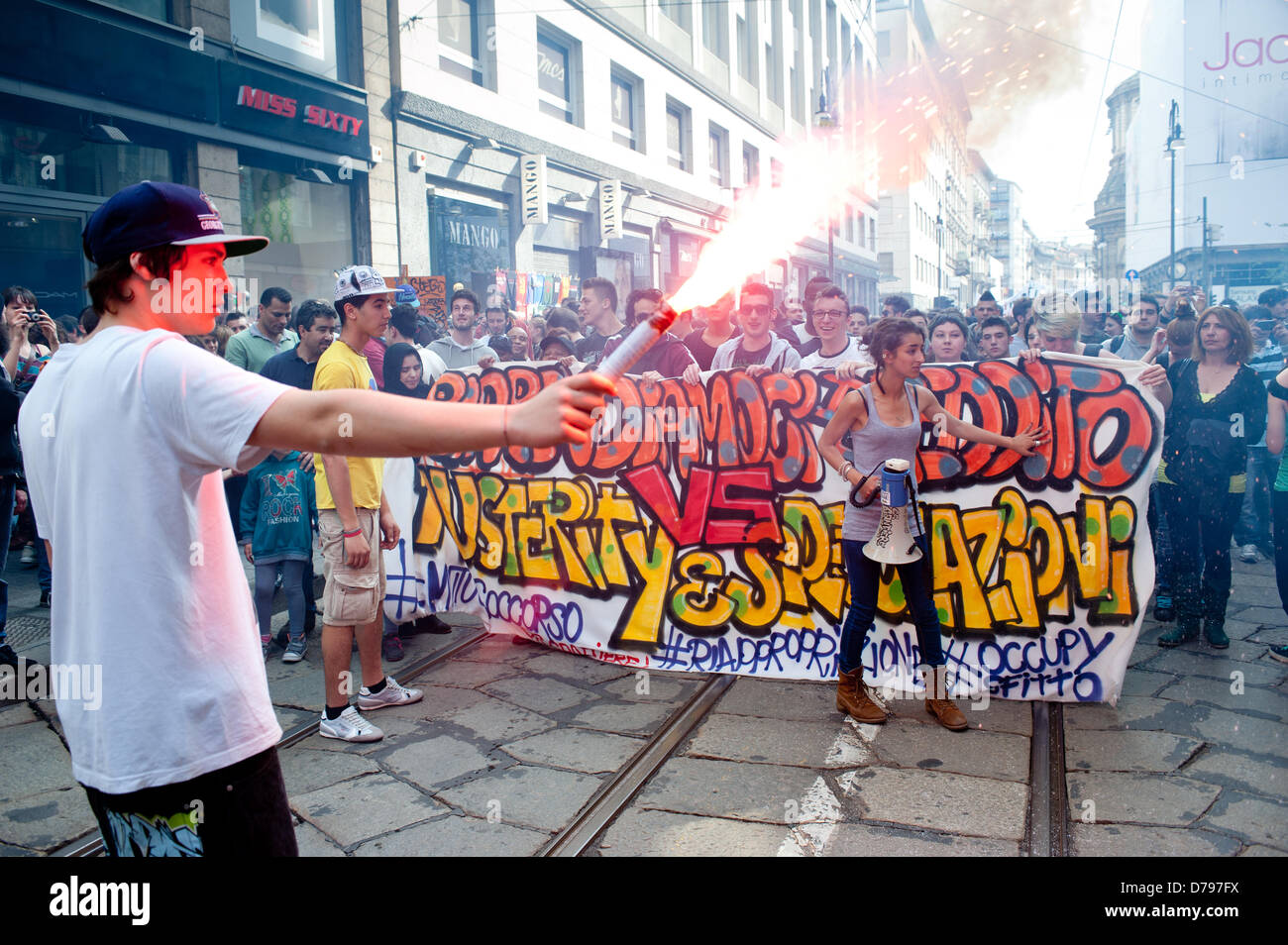 Milan, Italy - 1 May 2013: a boy holds a fired teargas during the celebrations of May Day in Milan where thousands gather to celebrate May Day and to protest against austerity measures.. Credit:  Piero Cruciatti / Alamy Live News Stock Photo