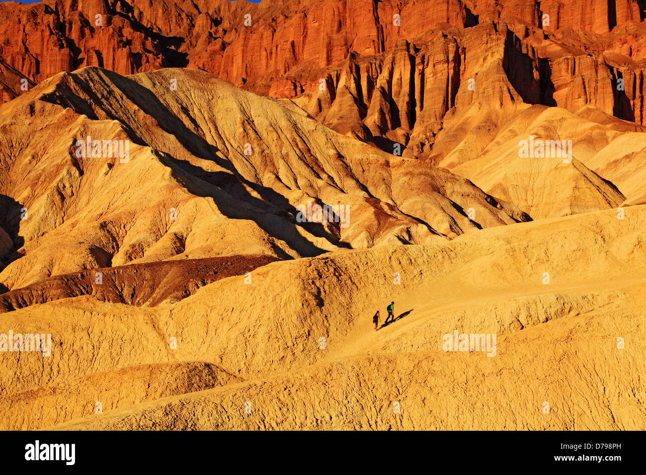 Hikers in Golden Canyon Beneath Red Cathedral in Death Valley National ...