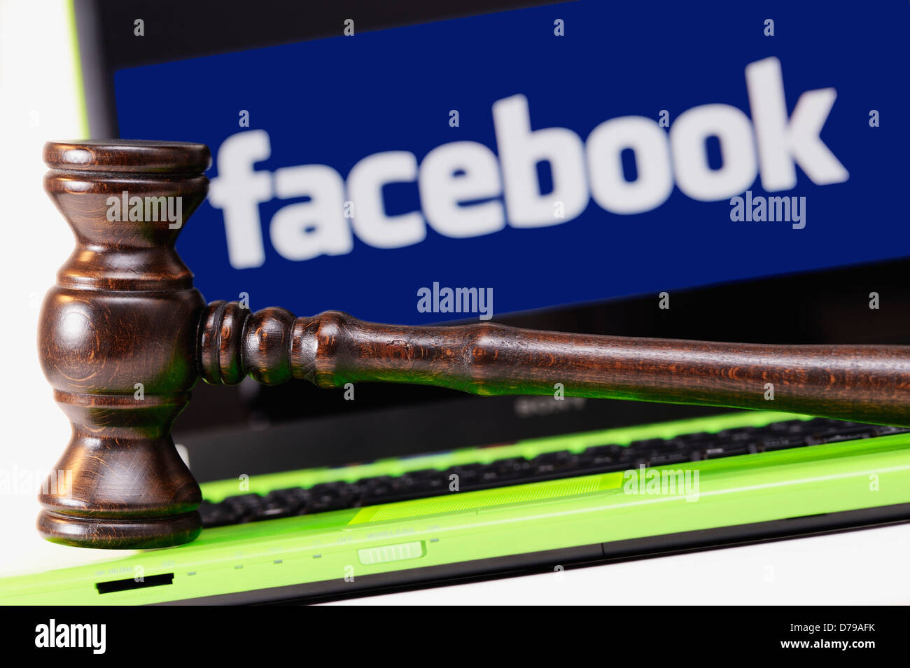 Judge's hammer before computer with Facebook logo , Richterhammer vor Computer mit Facebook-Logo Stock Photo