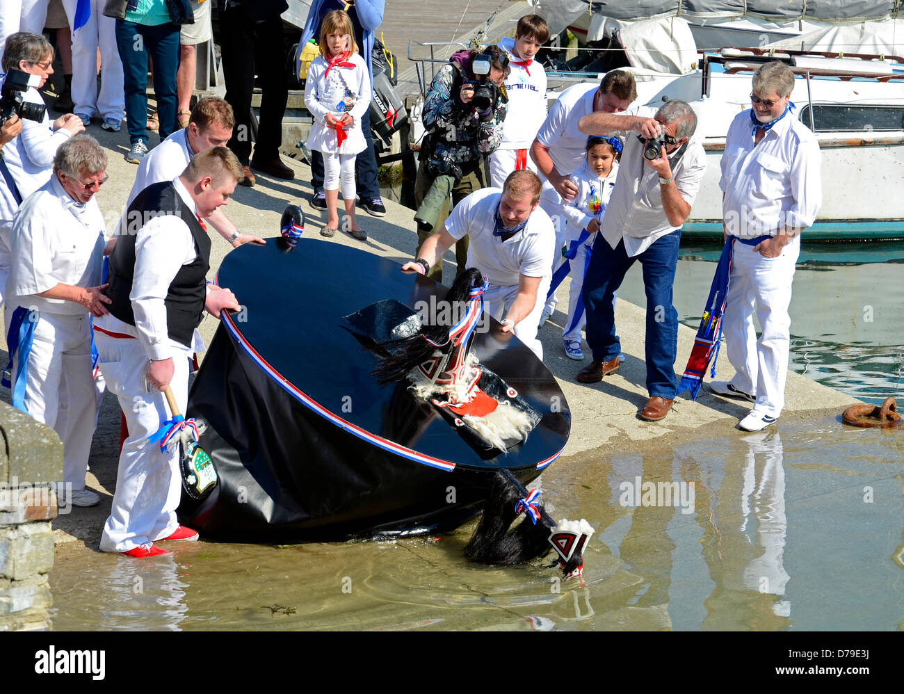 Padstow, Cornwall, UK. 1st May 2013. ' The Blue Oss ' takes a refreshing drink from the harbour Stock Photo