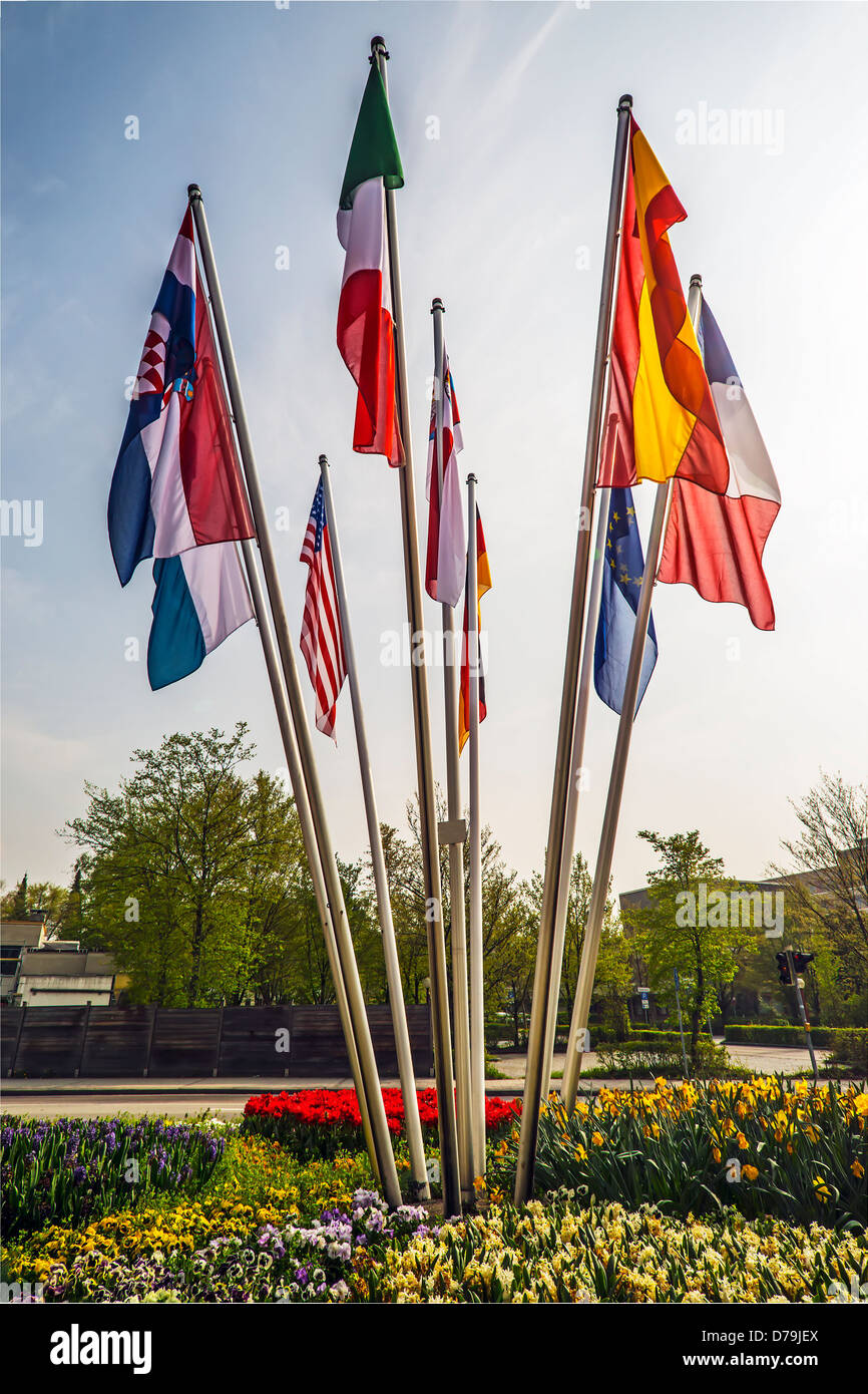 Flags on flagpoles of different countries of the world Stock Photo